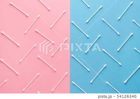 pink and blue background and white cotton swabs, flat lay pink and blue background and white cotton swabs, flat lay 54126340