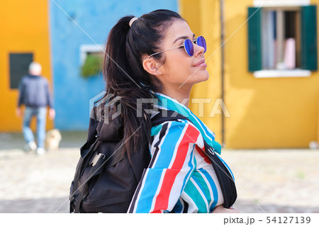 A girl with a backpack visits a colorful Italian A girl with a backpack visits a colorful Italian 54127139