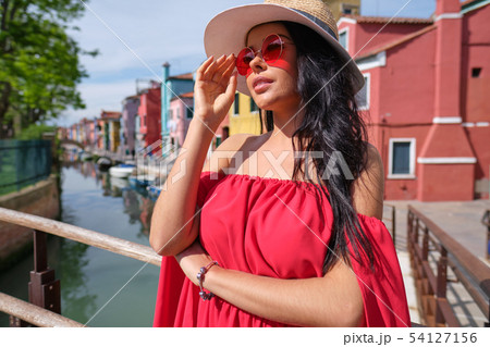 traveler woman posing among colorful houses on traveler woman posing among colorful houses on 54127156