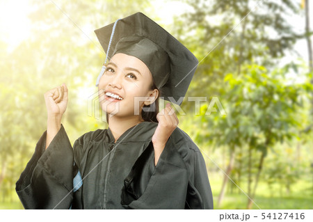 Asian woman in mortarboard hat graduating 54127416