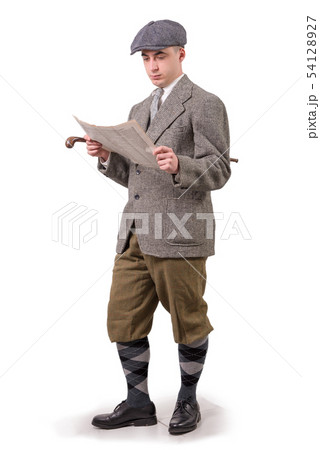 young man in vintage clothes with hat, reading a 54128927