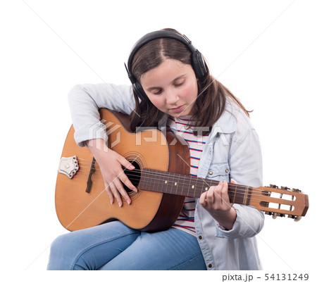 smiling teenager playing guitar on white smiling teenager playing guitar on white 54131249