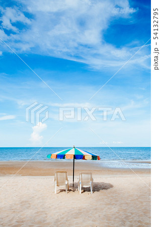 Beach beds and colourful umbrella with ocean 54132795