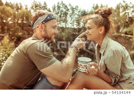 Delighted positive man touching his girlfriends nose 54134144