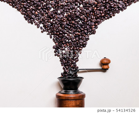 Roasted Coffee beans dropping into retro wooden 54134526