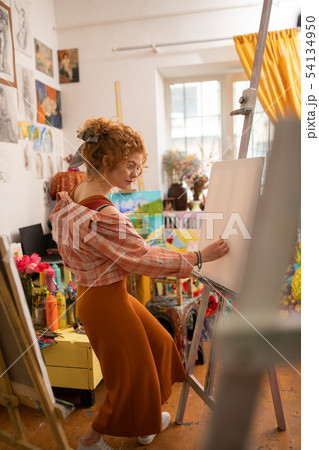 Curly young artist drawing at the weekend feeling relaxed 54134950