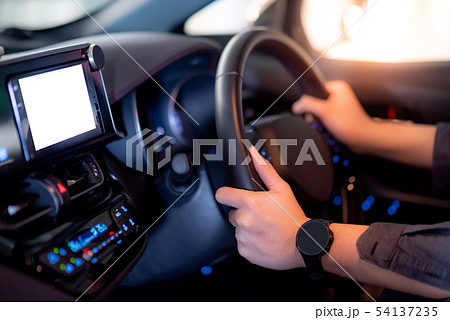 Driver hand holding steering wheel in the car 54137235