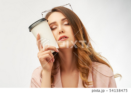 woman office worker holds a Cup of coffee at head 54138475