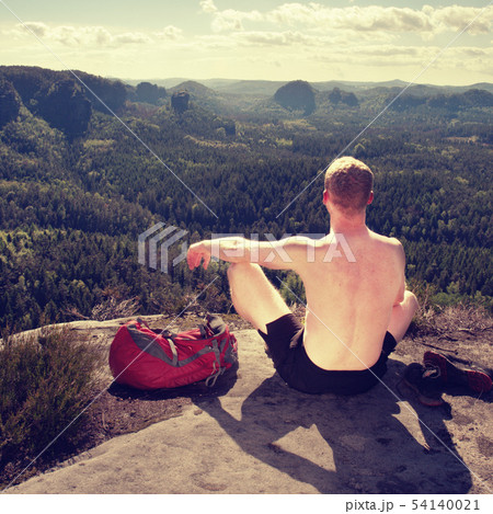 Shirtless man relaxing meditation with serene view Shirtless man relaxing meditation with serene view 54140021