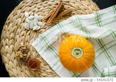 Small pumpkin with seeds, can of honey Small pumpkin with seeds, can of honey 54141373