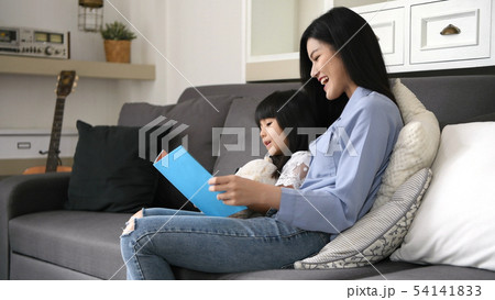 Family concept. Mother and daughter are reading Family concept. Mother and daughter are reading 54141833
