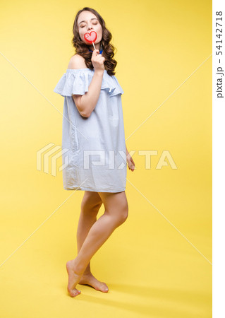Seductive woman like sweet doll with candy. Seductive woman like sweet doll with candy. 54142718