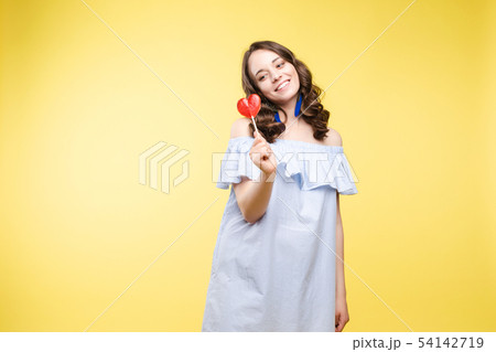 Fashionable young woman with lolipop in her hands Fashionable young woman with lolipop in her hands 54142719