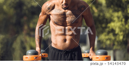 Shirtless Guy Doing Push Ups On Parallel Bars 54143470
