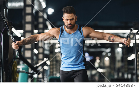 Handsome bodybuilder working out pushing up exercise in gym Handsome bodybuilder working out pushing up exercise in gym 54143937