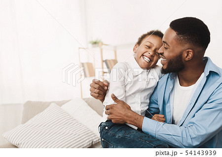 Afro Father Tickling Daughter, Having Fun And Playing At Home Afro Father Tickling Daughter, Having Fun And Playing At Home 54143939