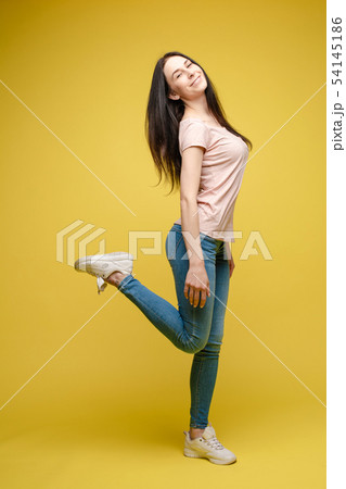 Cheerful brunette young woman in casual outlook Cheerful brunette young woman in casual outlook 54145186