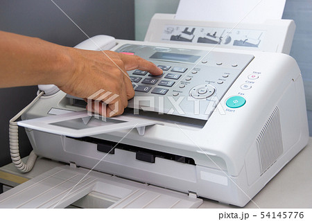 hand man are using a fax machine in the office hand man are using a fax machine in the office 54145776