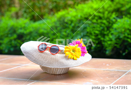 Beach hat with sunglasses and gerbera daisy 54147391