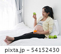 Asian pregnant woman drinking orange juice and 54152430