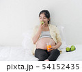 Asian pregnant woman drinking orange juice and 54152435