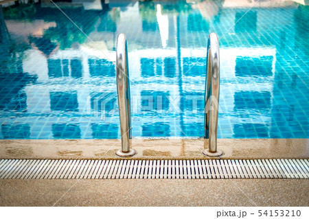metal steel handle at edge poolside of swimming pool in hotel 54153210