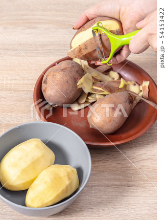 woman cook cleans potatoes woman cook cleans potatoes 54153422