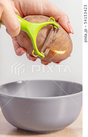 woman cook cleans potatoes woman cook cleans potatoes 54153423