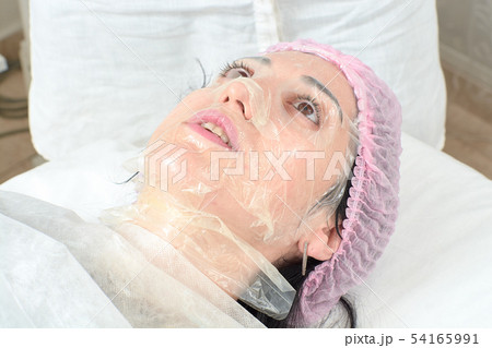 Young woman in beauty salon doing peeling and 54165991