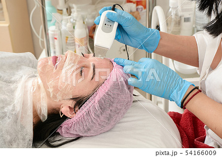Young woman in beauty salon doing peeling and 54166009