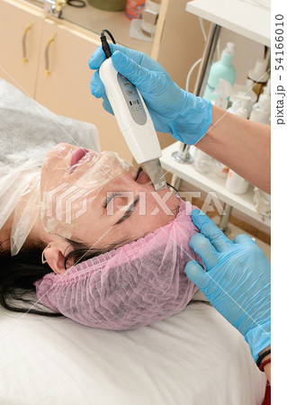 Young woman in beauty salon doing peeling and 54166010