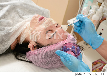 Young woman in beauty salon doing peeling and 54166011