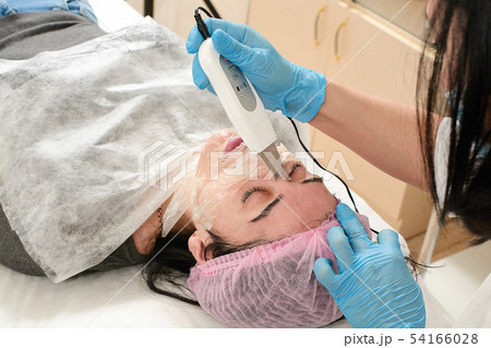 Young woman in beauty salon doing ultrasound Young woman in beauty salon doing ultrasound 54166028