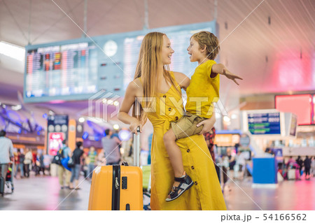 Family at airport before flight. Mother and son waiting to board at departure gate of modern Family at airport before flight. Mother and son waiting to board at departure gate of modern 54166562