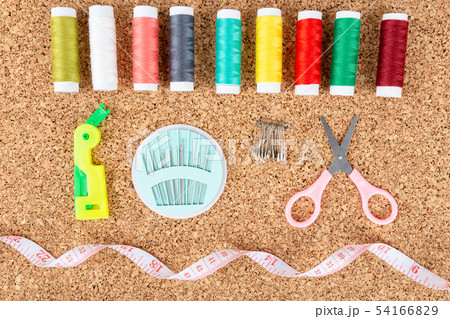 Sewing kit with colorful spools of threads and 54166829