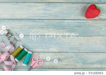 Tools for sewing and needlework on green wooden Tools for sewing and needlework on green wooden 54166903