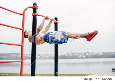 Handsome man training in a summer park 54168596