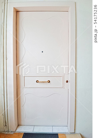 Closeup view of light pink wooden front door with peephole Closeup view of light pink wooden front door with peephole 54175236
