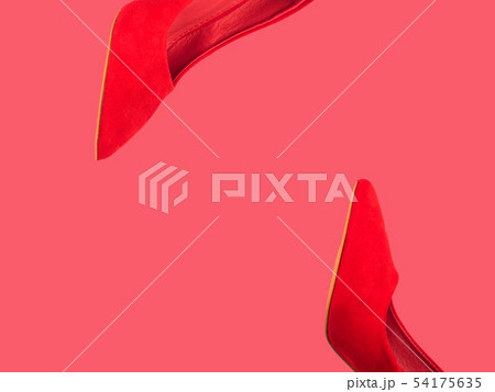 Red female pumps isolated on coral pink Red female pumps isolated on coral pink 54175635