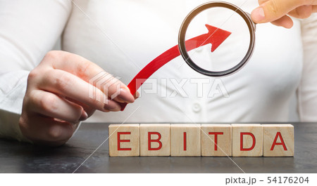 Woman holds up arrow over wooden blocks Woman holds up arrow over wooden blocks 54176204