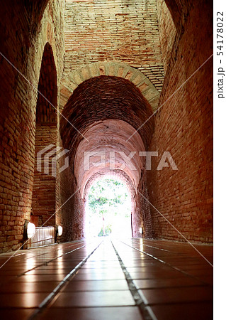 The old tunnel with a light in the end at Wat 54178022