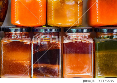 Honey market with various types of honey in jars close Honey market with various types of honey in jars close 54179059