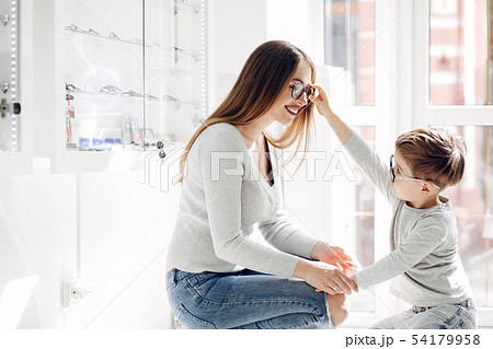 Mother with little son in the glasses store Mother with little son in the glasses store 54179958