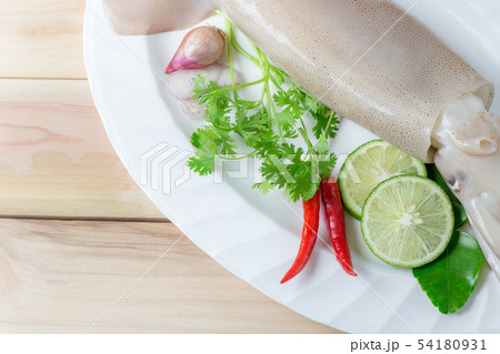 fresh squid with lemon and parsley. Whiteraw squid fresh squid with lemon and parsley. Whiteraw squid 54180931