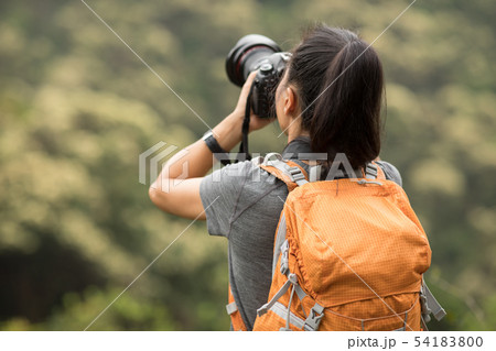 woman photographer taking photo on morning woman photographer taking photo on morning 54183800