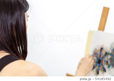 Artist painting on an easel 54185492