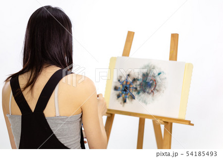 Artist painting on an easel 54185493