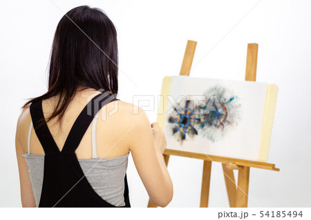 Artist painting on an easel 54185494
