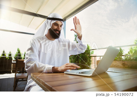 Arabian saudi businessman working outdoors 54190072