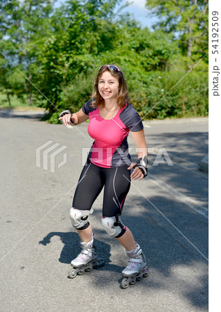 pretty young woman doing rollerskate on a track 54192509